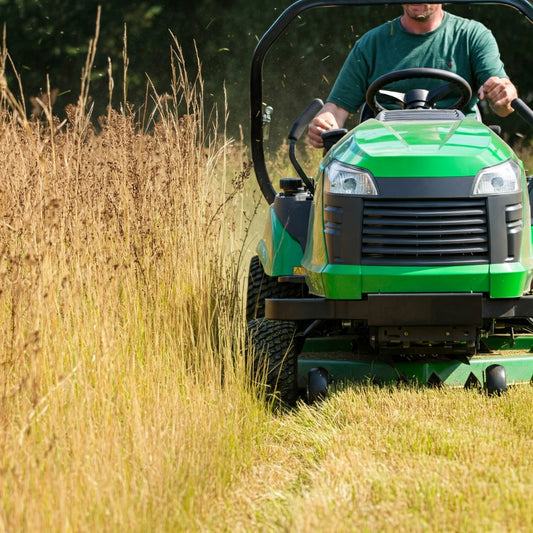 Man on a mower doing site preparation for a tree planting